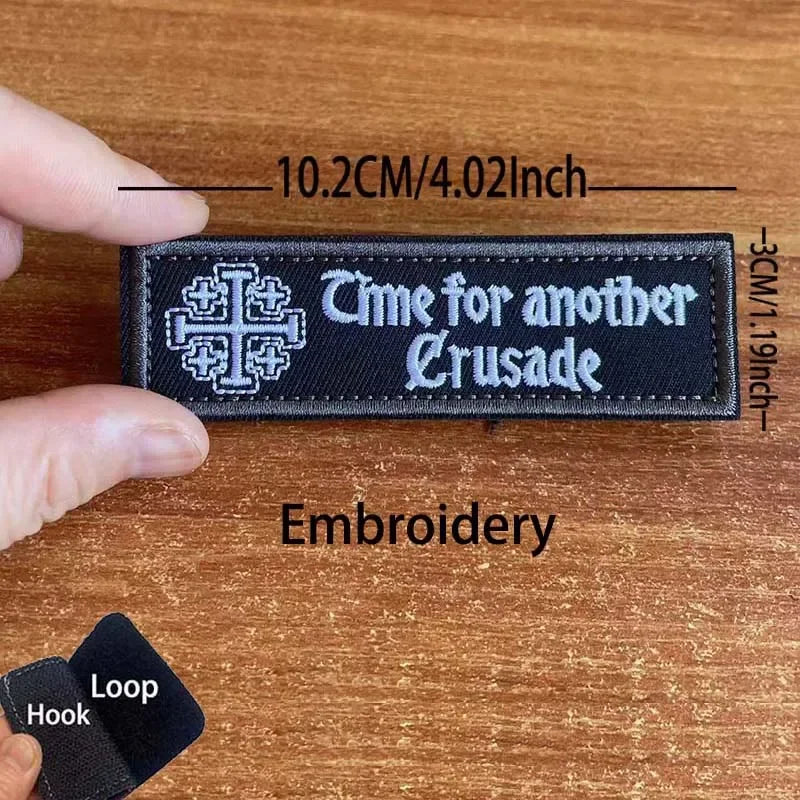 Black embroidered tactical patch with the text Time for another Crusade and a cross symbol