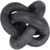 A black handcrafted rustic wood knot decor item used as a boho coffee table accent.