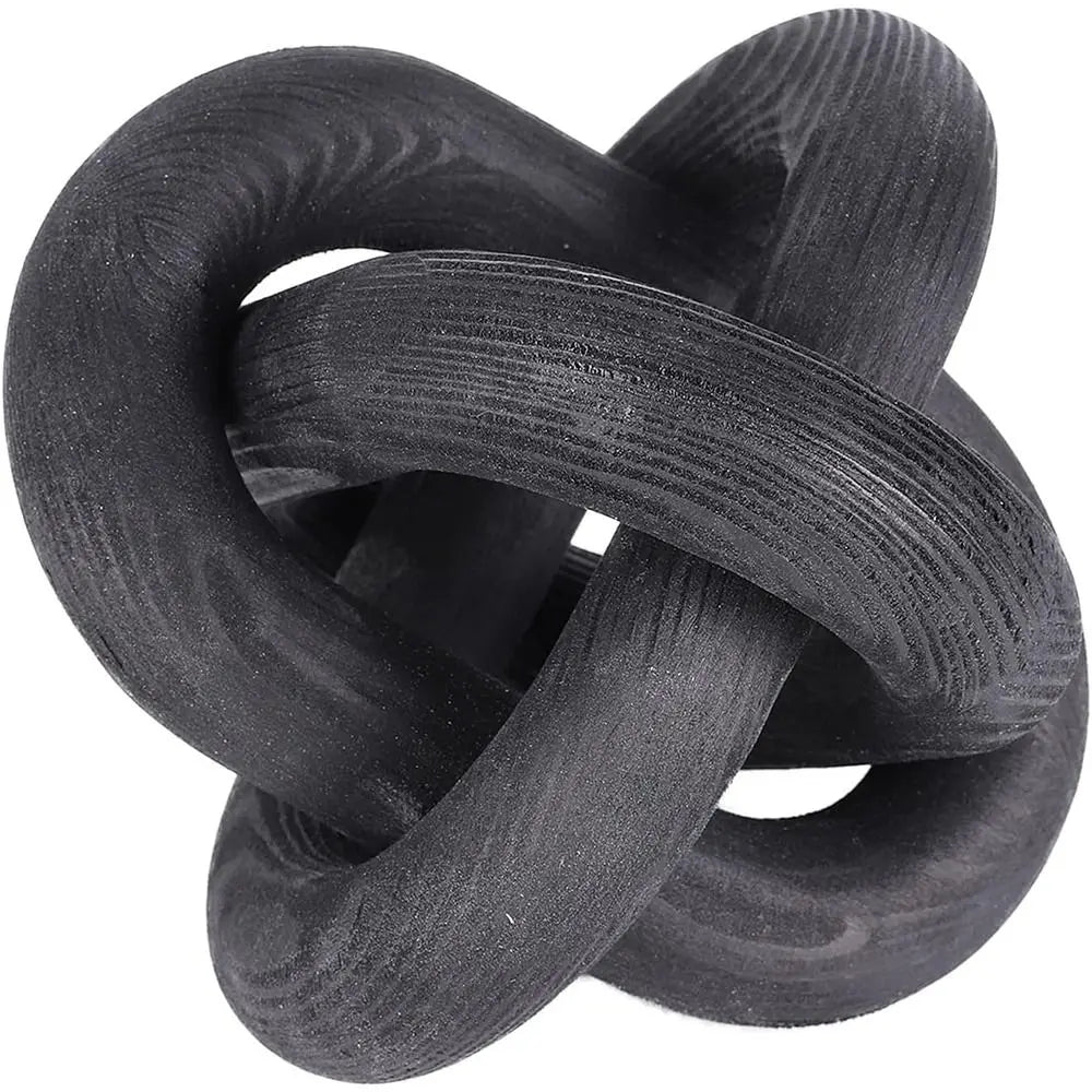 A black handcrafted rustic wood knot decor item used as a boho coffee table accent.