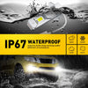 A yellow car's fog light is illuminated while driving through water spray.