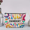 A canvas charger storage pouch with various colored charging cables and adapters is displayed on a light wooden surface.