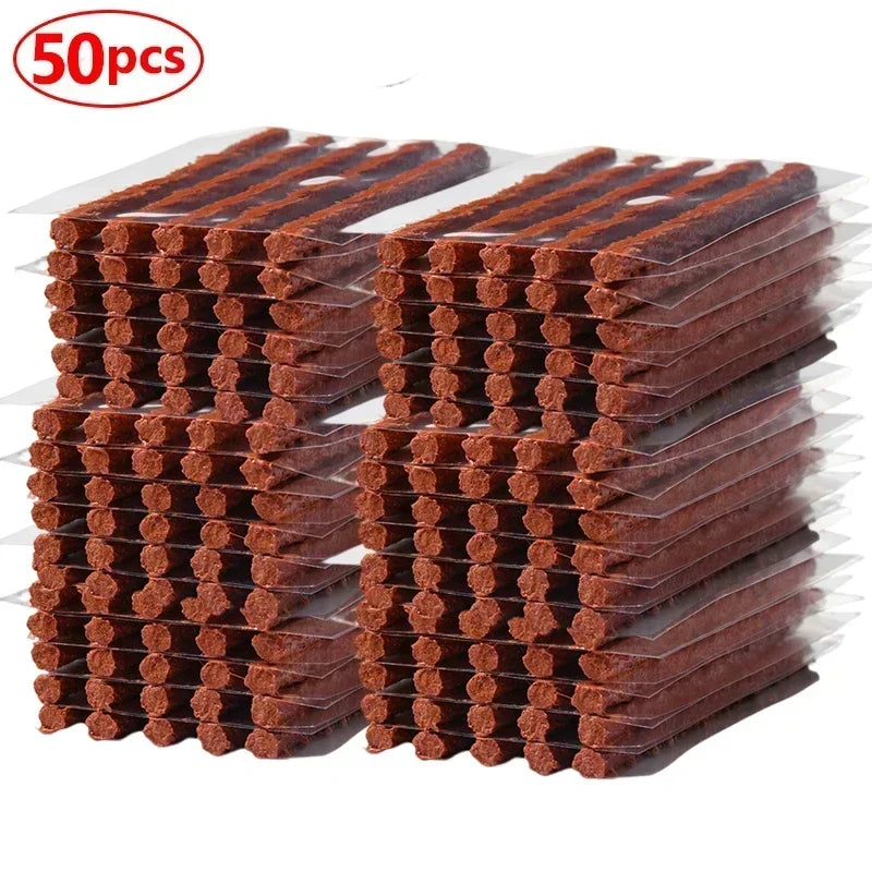 A stack of universal emergency tubeless tire repair kits, showing multiple rows of brown rubber patches.
