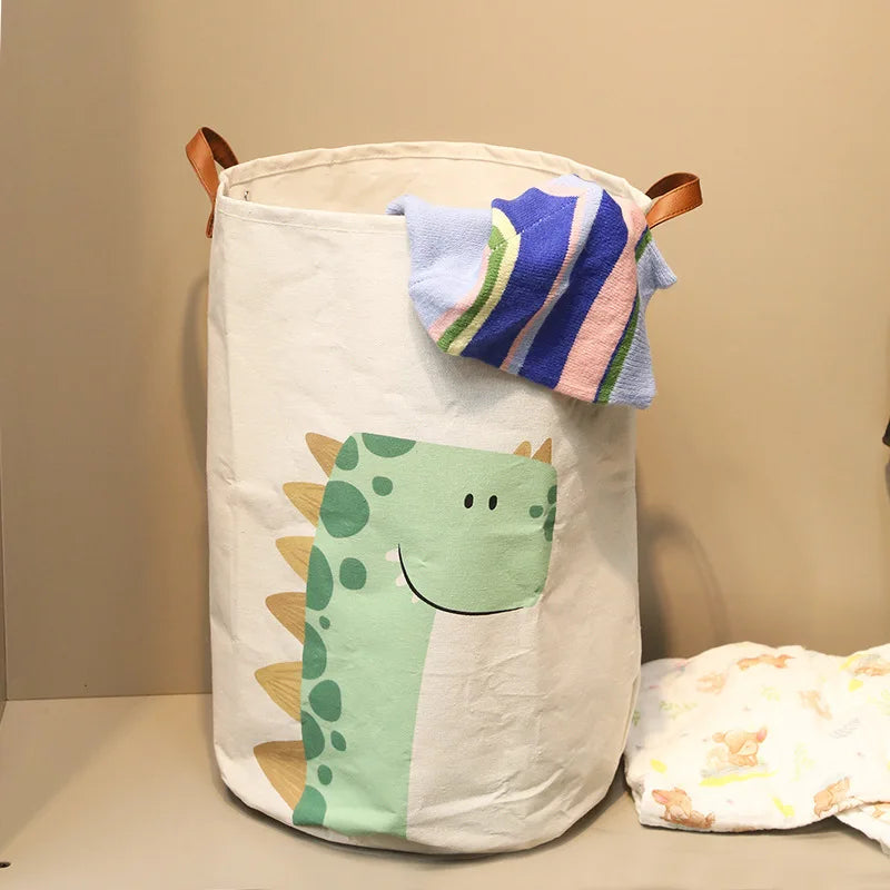 A white fabric storage basket with a dinosaur print and a blue striped cloth organizer inside.