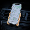 A crystal air vent car phone holder displaying a map on a smartphone screen.