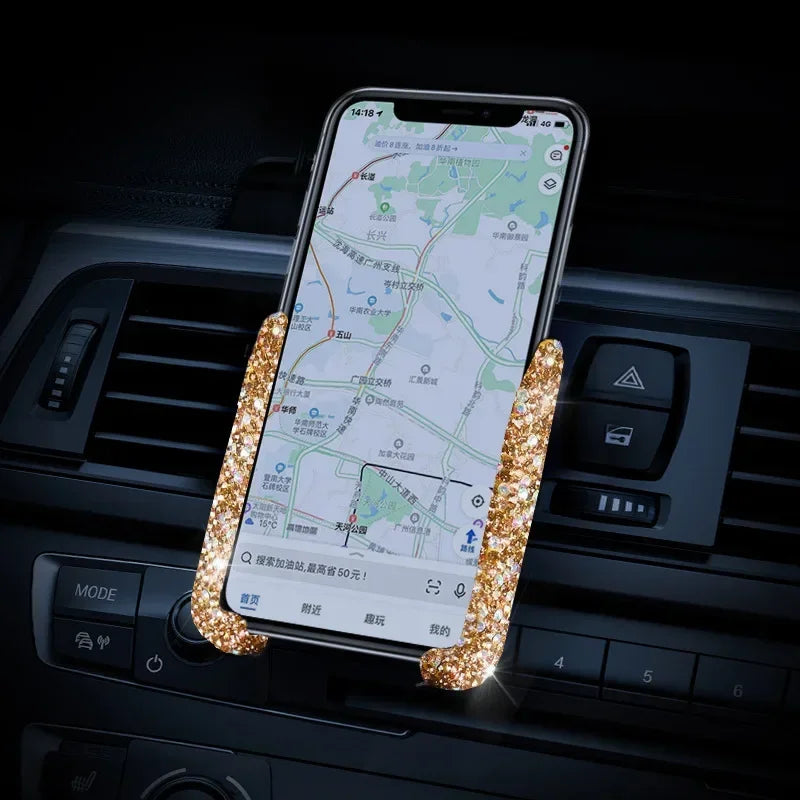 A crystal air vent car phone holder displaying a map on a smartphone screen.