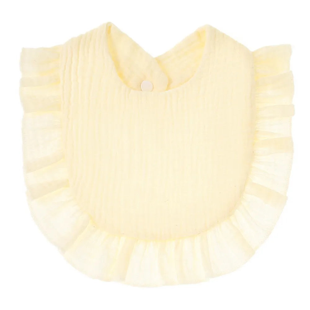 A pale yellow, ribbed cotton baby bib in a ruffle style with a button closure.