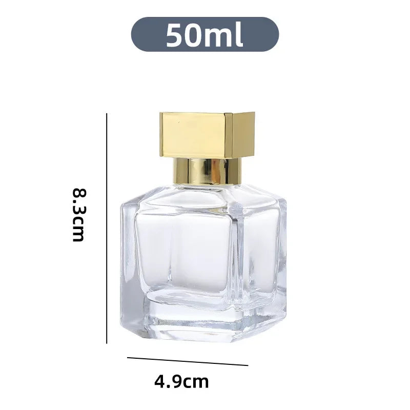 A clear glass perfume bottle with a gold-colored cap and sprayer, labeled as a 50ml refillable bottle.