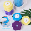Yellow and purple disposable toilet brush replacement heads shown next to a cup and green leaves.