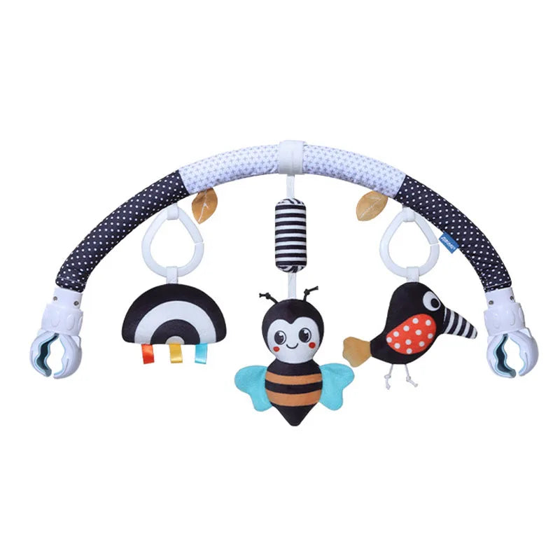 A baby stroller arch toy featuring a curved white and black striped bar with hanging plush charms including an owl, bee, and 