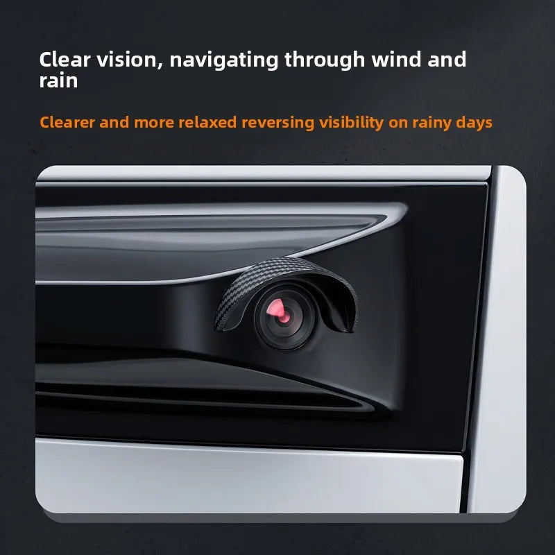 A close-up view of a car rear camera with a clear reversing visibility rain cover installed.