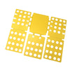 A yellow magic clothes folding board with multiple compartments for organizing t-shirts.