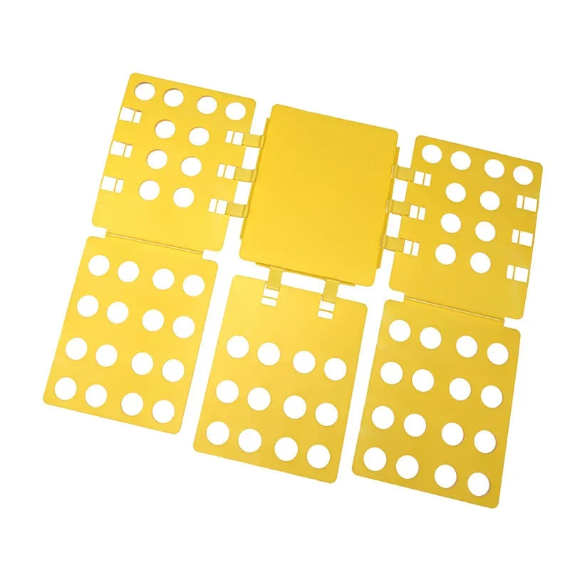 A yellow magic clothes folding board with multiple compartments for organizing t-shirts.