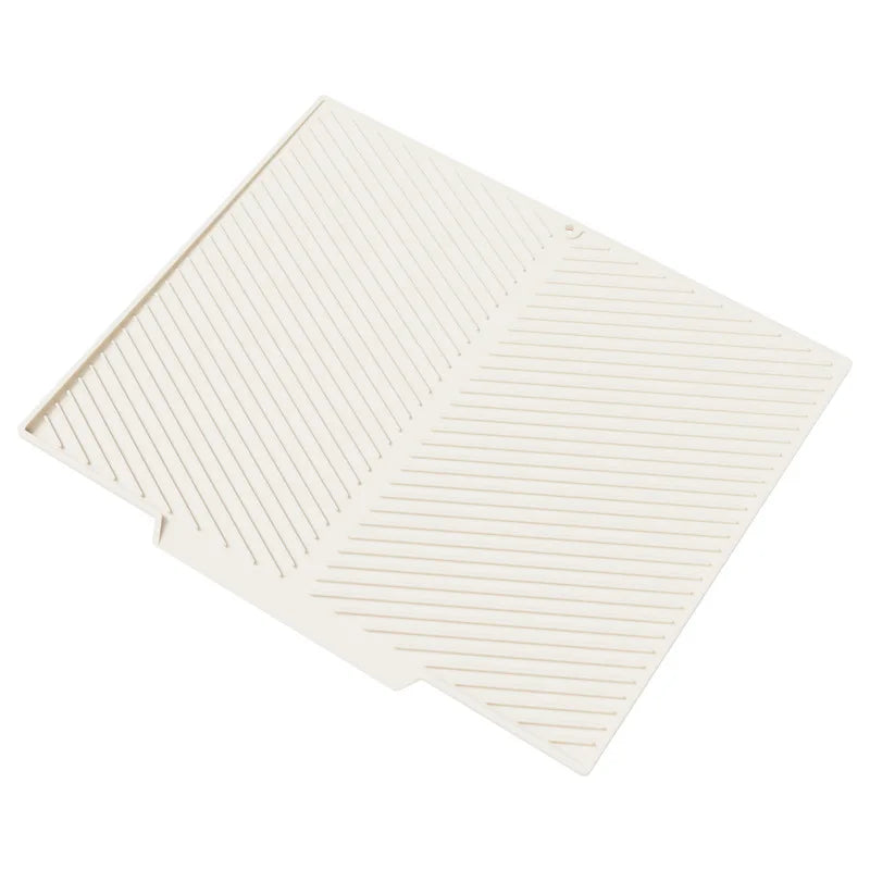A beige silicone dish drying mat with ribbed texture, shown from an angled view.