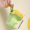 A hand is holding a green and yellow leakproof travel soap case with a secure lid, showing its design and dimensions.