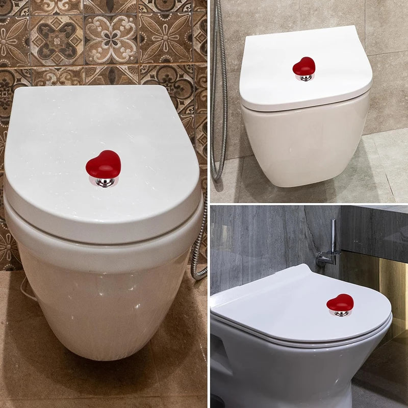 A white toilet featuring a heart-shaped flush button with a red design.