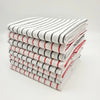 A stack of striped lint-free kitchen dishcloths in white, black, and red stripes.