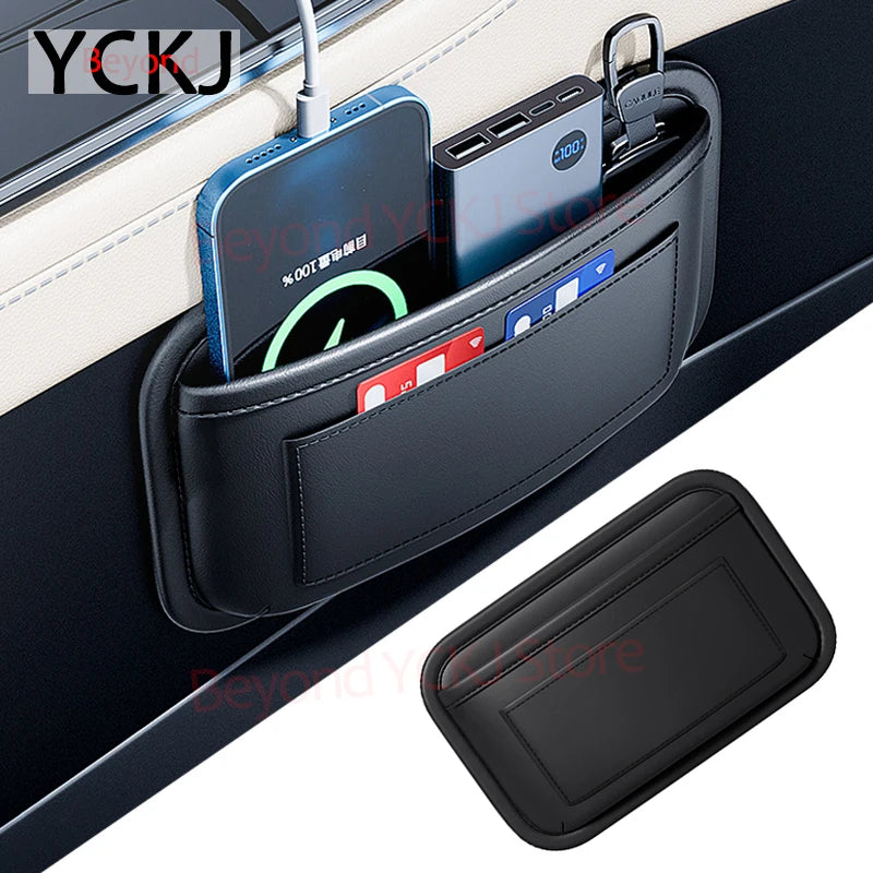A black organizer bag with a side pocket holding various electronic devices and cards inside a car seat.