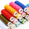Rolls of vibrant colored thread in various shades including pink, orange, yellow, and blue.
