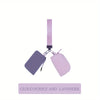 A lilac wristlet wallet with a pink strap and a detachable coin pouch.