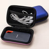 A black protective case for a SanDisk Extreme portable SSD, featuring a blue outer shell and a purple inner sleeve.