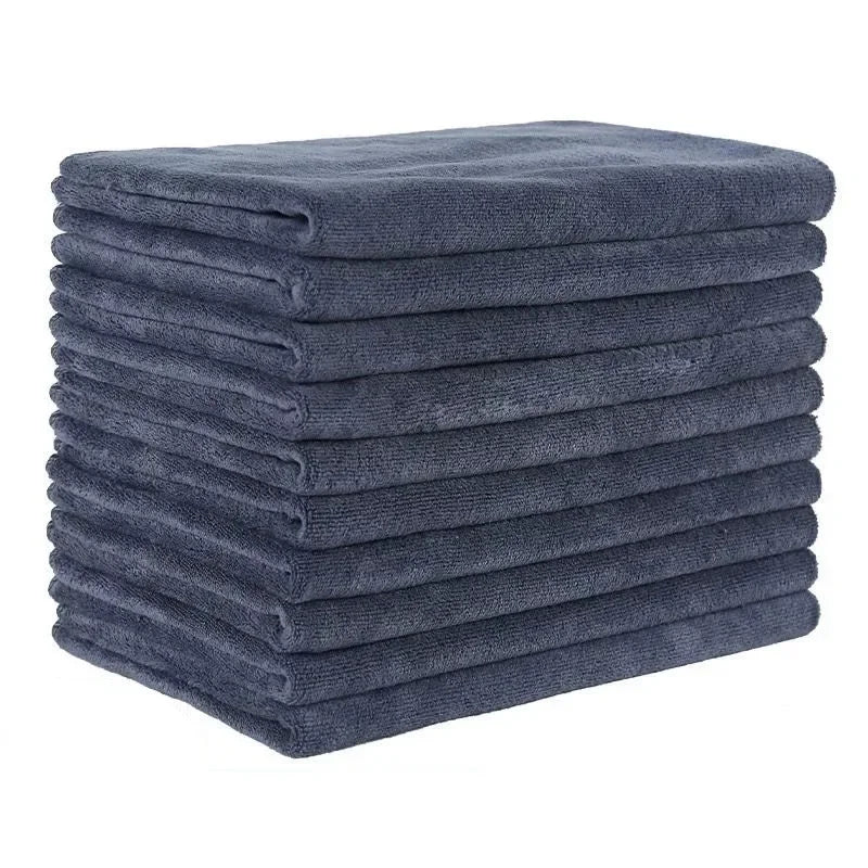 A stack of dark blue microfiber bath towels.