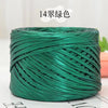 A spool of metallic green flat ribbon yarn for crochet and knitting