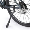 A close-up view of a black bicycle kickstand attached to the frame and wheel.