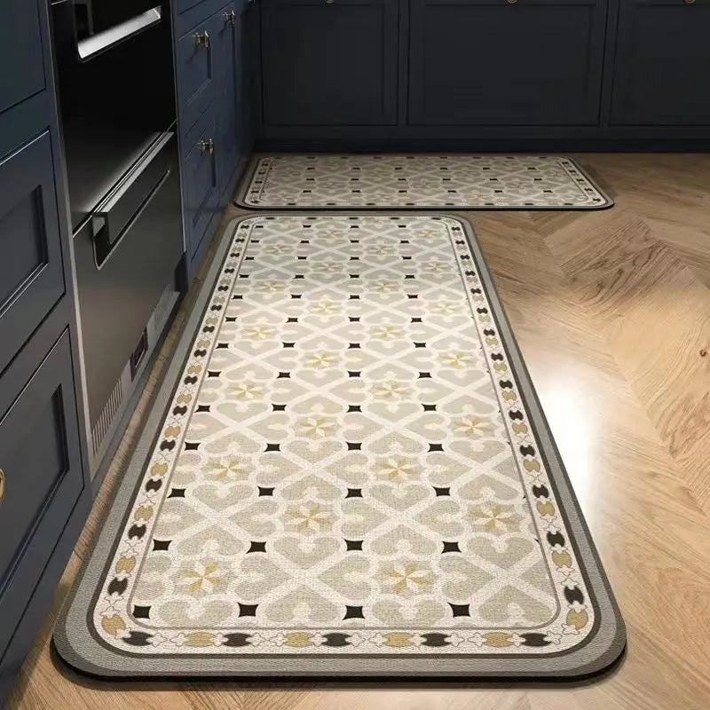 A long rectangular kitchen rug with a classic beige and black Persian print is placed on a light wood floor.
