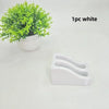 A white double slot wall-mounted wrench organizer rack with curved slots.