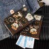 A brown leather passport holder with cartoon animal designs is placed on a denim jacket.