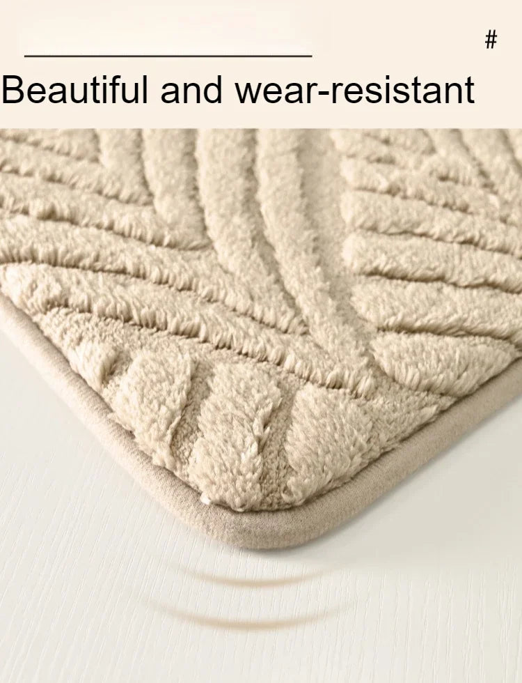 A close-up view of a beige plush velvet bathroom mat with a textured, non-slip surface.