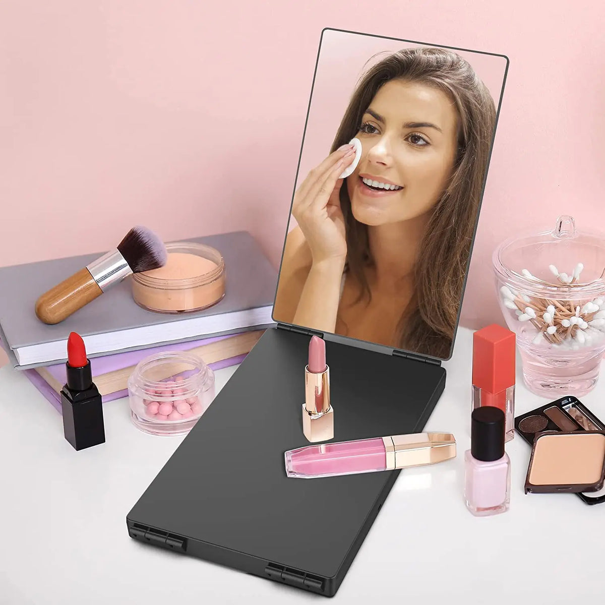 A woman is shown in a mirror reflection while using a 360° Trifold LED Haircut Mirror with various beauty products.