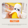 A yellow plush banana toy with a white face is being held by hands to create a beat.