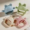 Three silicone cat-shaped teethers in blue, green, and pink are shown against a light background.