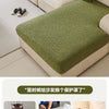 A light green jacquard fleece sofa cover with a textured pattern displayed on a beige sofa.