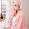 A woman is wrapped in a pink plush coral velvet bath towel three-piece set with white clothing.