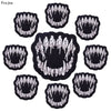 A set of ten black and white embroidered iron-on patches featuring skull and horror designs.