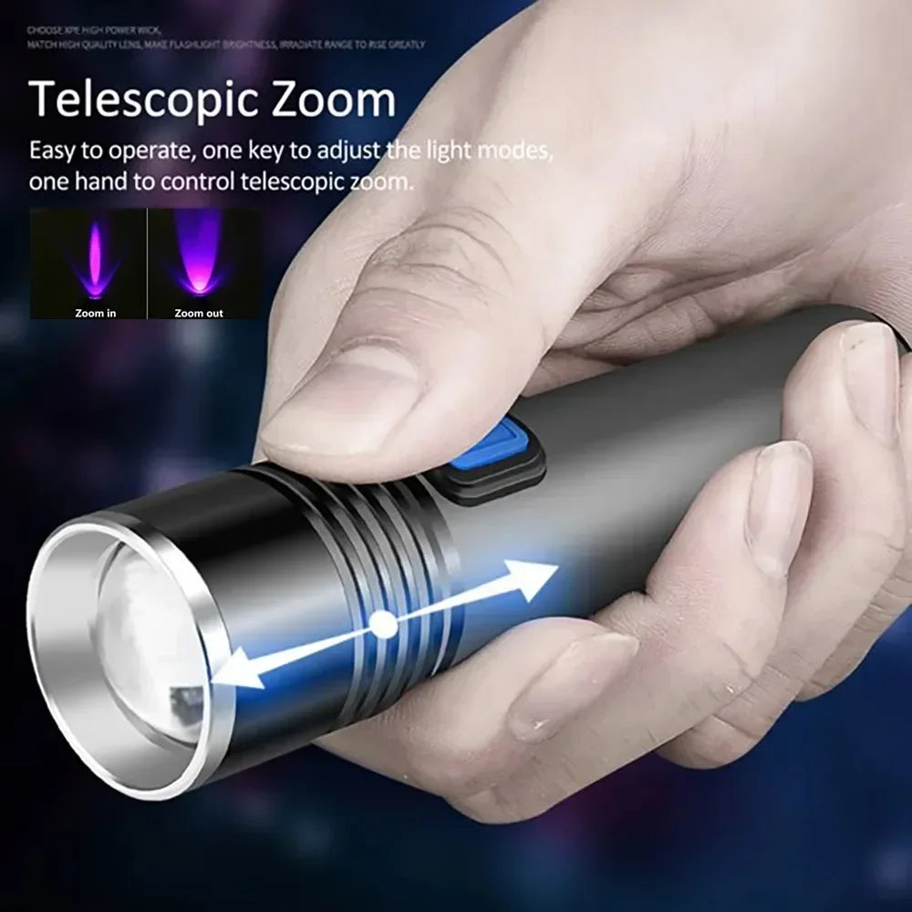 A hand holds a black flashlight with a zoom lens, demonstrating the telescopic zoom feature.