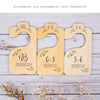 A set of eight wooden baby closet dividers for organizing clothes, labeled with age ranges from newborn to 3-6 months.
