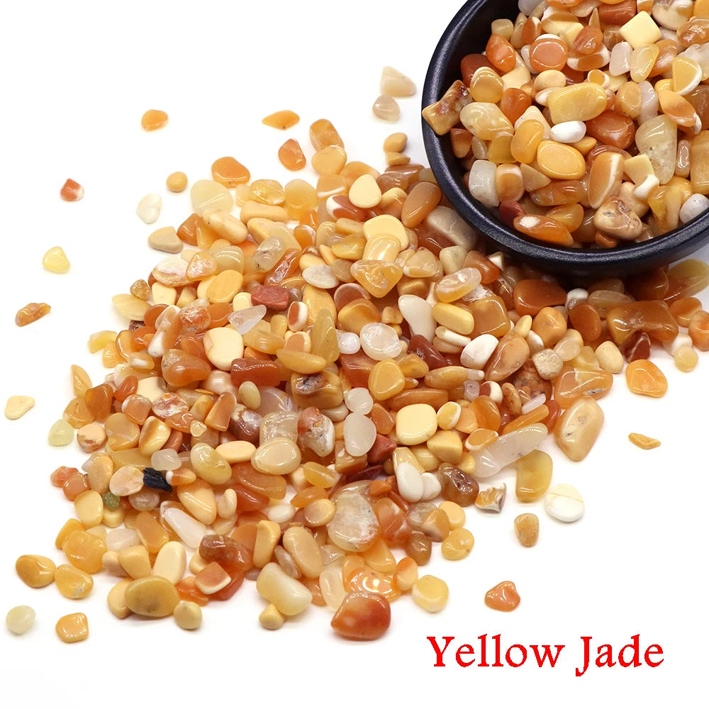 Yellow Jade natural tumbled crystal stone chips scattered on a white background.