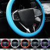 A close-up view of a blue silicone steering wheel cover installed on a car's steering wheel.