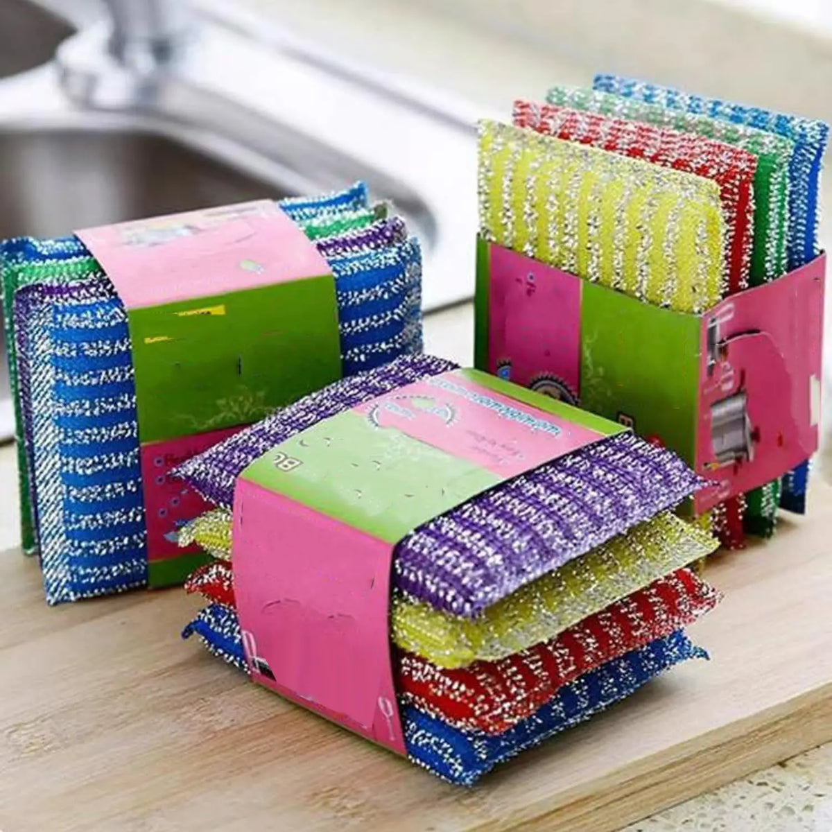 A stack of colorful double-sided kitchen scouring sponges in various shades of pink, green, blue, and yellow.