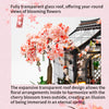 A transparent glass roof structure showcasing blooming pink cherry blossom trees and floral arrangements.