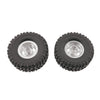A pair of black RC car upgrade wheels with shiny metal rims and soft tires.