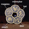 A set of traditional Chinese Feng Shui brass lucky coins featuring animals like magpies, bat, peach, and deer.