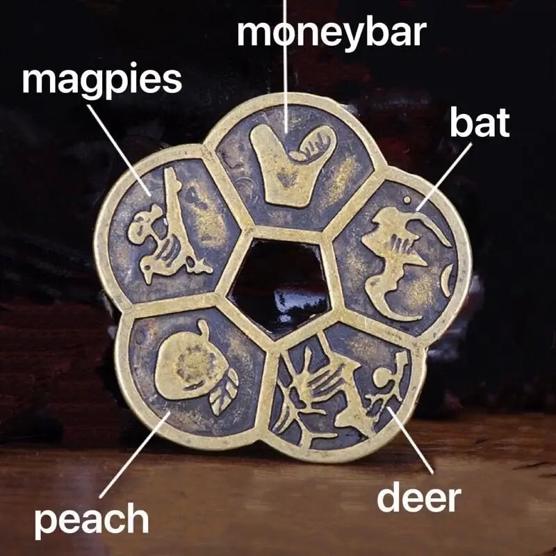 A set of traditional Chinese Feng Shui brass lucky coins featuring animals like magpies, bat, peach, and deer.