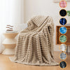 A beige brushed flannel throw blanket draped on a sofa, with color swatches displayed nearby.