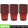 Sixteen terracotta-colored plastic seedling pots stacked in a row.