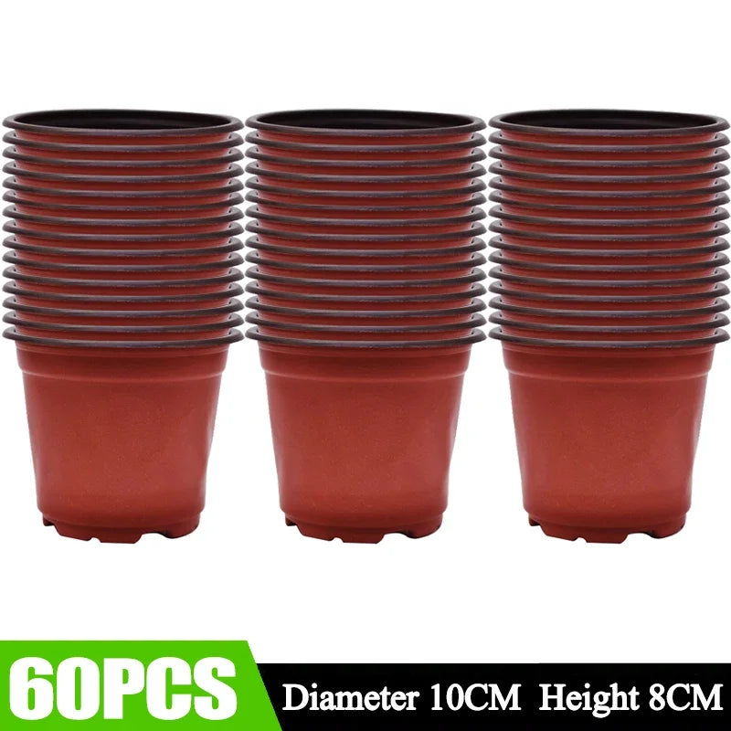 Sixteen terracotta-colored plastic seedling pots stacked in a row.