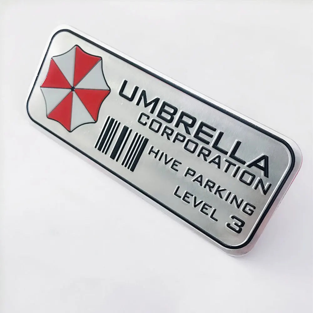 Silver aluminum alloy sticker with an umbrella logo and text indicating Umbrella Corporation Hive Parking Level 3